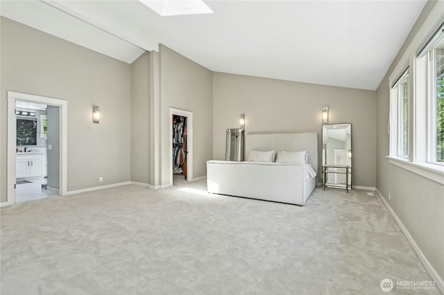 17519 33rd Ave NE, Lake Forest Park, WA 98155 - bedroom featuring vaulted ceiling, a walk in closet, light colored carpet, ensuite bathroom, and a skylight