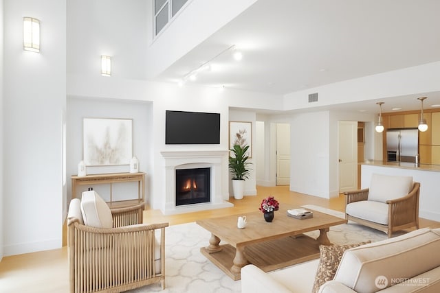 745 Bellevue Ave E Unit 109, Seattle, WA 98102 - living area with a glass covered fireplace and track lighting