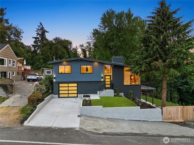 11029 84th Ave S, Seattle, WA 98178 - modern home featuring driveway, an attached garage, and a chimney