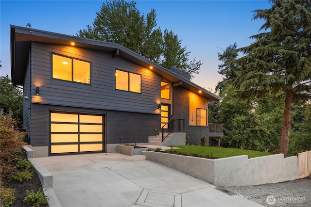 11029 84th Ave S, Seattle, WA 98178 - modern home with a garage, concrete driveway, and brick siding