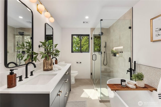 11029 84th Ave S, Seattle, WA 98178 - bathroom featuring double vanity, a freestanding bath, a shower stall, and recessed lighting