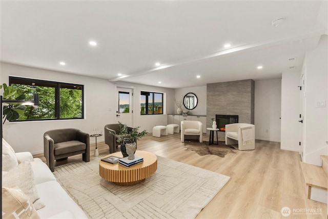 11029 84th Ave S, Seattle, WA 98178 - living area with plenty of natural light, light wood-style floors, a fireplace, and recessed lighting
