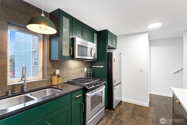 1541 18th Ave S, Seattle, WA 98144 - kitchen with appliances with stainless steel finishes, green cabinetry, dark wood-style flooring, and tasteful backsplash