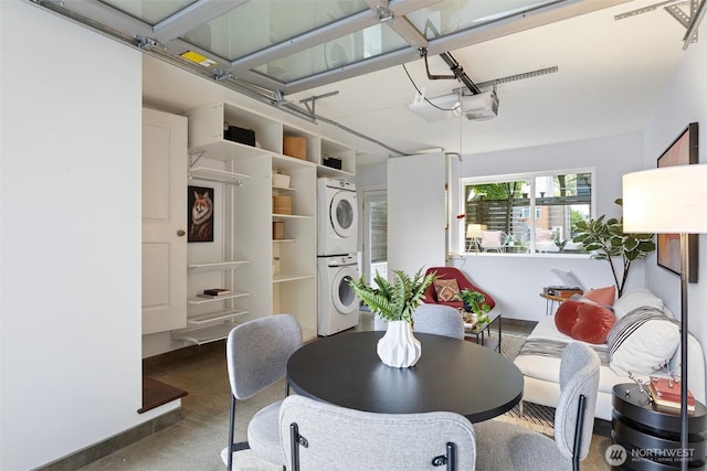 1541 18th Ave S, Seattle, WA 98144 - dining room featuring stacked washer / dryer and finished concrete floors