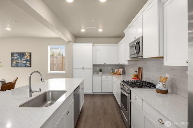 1312 Baker Heights Loop, Bremerton, WA 98312 - kitchen with appliances with stainless steel finishes, tasteful backsplash, light stone counters, white cabinets, and recessed lighting