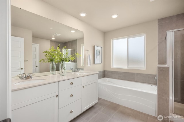 1312 Baker Heights Loop, Bremerton, WA 98312 - bathroom featuring a garden tub, double vanity, a shower stall, recessed lighting, and tile patterned floors