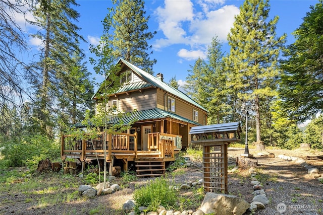 7 Moonshine Ln, Ronald, WA 98940 - view of front of house featuring a wooden deck, a metal roof, a chimney, and stairway