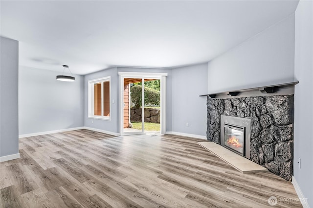 12608 NE 119th St Unit B8, Kirkland, WA 98034 - unfurnished living room featuring a stone fireplace and wood finished floors