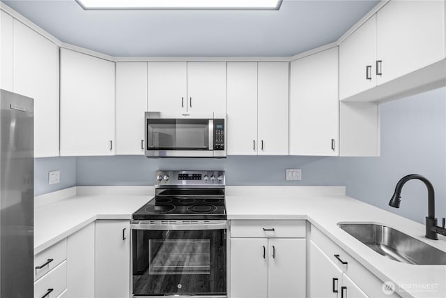 12608 NE 119th St Unit B8, Kirkland, WA 98034 - kitchen with stainless steel appliances, white cabinets, and light countertops