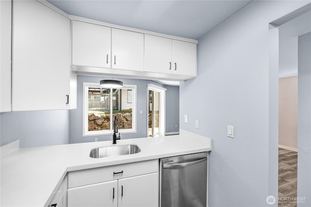 12608 NE 119th St Unit B8, Kirkland, WA 98034 - kitchen with dishwasher, light countertops, white cabinets, and wood finished floors