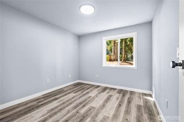 12608 NE 119th St Unit B8, Kirkland, WA 98034 - unfurnished room with wood finished floors and baseboards