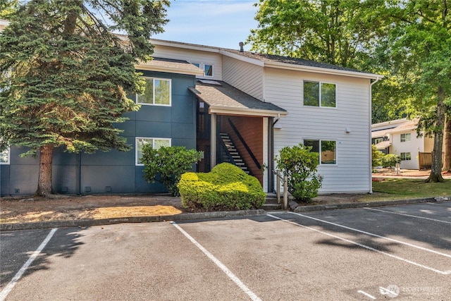 12608 NE 119th St Unit B8, Kirkland, WA 98034 - view of front of property with stairs, uncovered parking, and a shingled roof