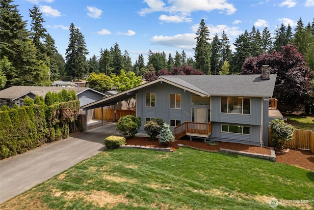 13002 145th St E, Puyallup, WA 98374 - split foyer home with a chimney, asphalt driveway, and a carport