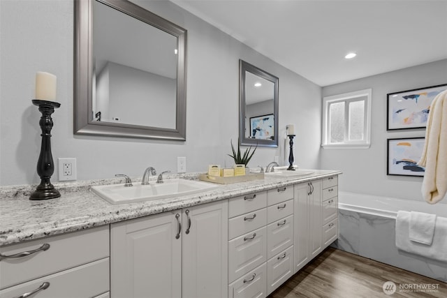 13002 145th St E, Puyallup, WA 98374 - full bath featuring double vanity, wood finished floors, a bath, and recessed lighting