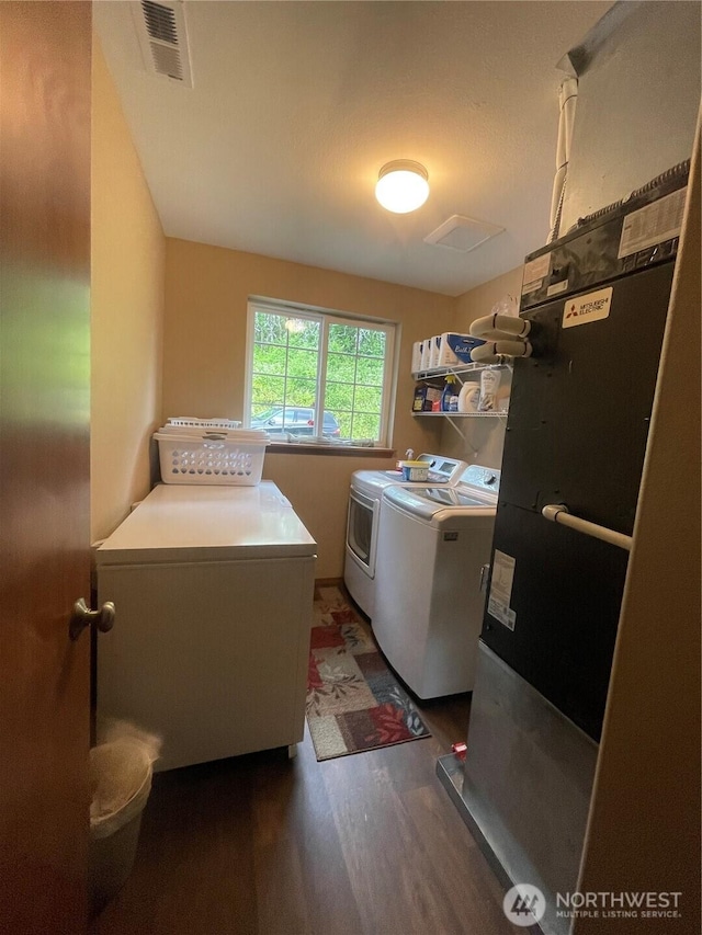 1717 Krause Rd, Raymond, WA 98577 - washroom featuring washing machine and dryer and wood finished floors