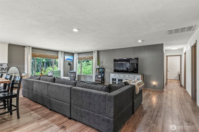 106 Barba Rd, Castle Rock, WA 98611 - living room with wood finished floors, a textured ceiling, and recessed lighting