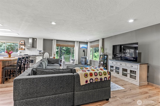 106 Barba Rd, Castle Rock, WA 98611 - living room with light wood-style flooring, a textured ceiling, plenty of natural light, and recessed lighting