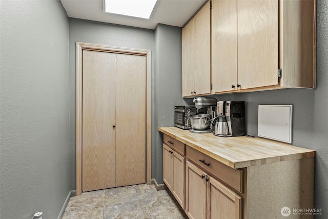 106 Barba Rd, Castle Rock, WA 98611 - kitchen with butcher block counters, light brown cabinetry, and a textured wall
