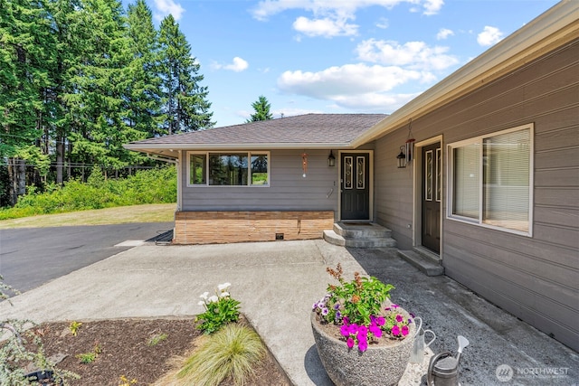 106 Barba Rd, Castle Rock, WA 98611 - view of exterior entry featuring a shingled roof and a patio area