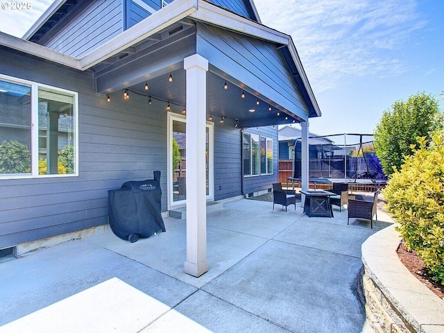 1706 NW 17th St, Battle Ground, WA 98604 - view of patio featuring a trampoline and an outdoor living space with a fire pit