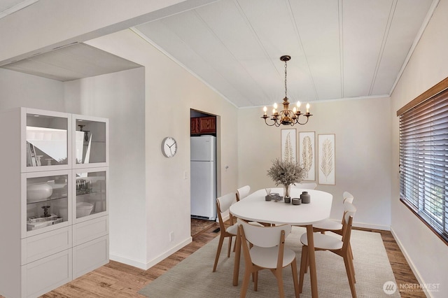 2500 Alder St Unit 335, Milton, WA 98354 - dining space featuring a chandelier, light wood-style flooring, and vaulted ceiling