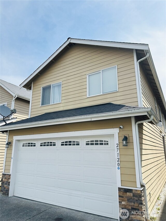 27120 105th Pl SE, Kent, WA 98030 - view of side of home with a garage and stone siding