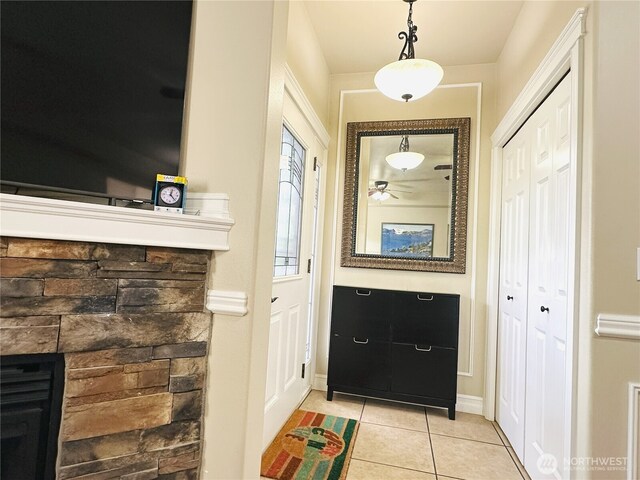 27120 105th Pl SE, Kent, WA 98030 - entrance foyer with light tile patterned floors, ceiling fan, and a stone fireplace