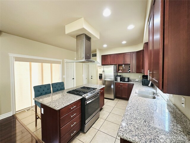 27120 105th Pl SE, Kent, WA 98030 - kitchen featuring stainless steel appliances, island exhaust hood, reddish brown cabinets, a kitchen bar, and a center island
