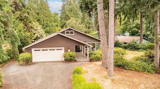 10761 Bill Point Crst NE, Bainbridge Island, WA 98110 - view of front facade with a garage, driveway, and covered porch