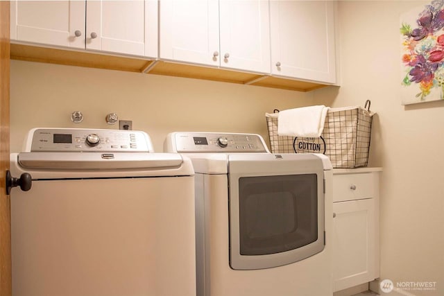 10761 Bill Point Crst NE, Bainbridge Island, WA 98110 - washroom featuring washing machine and clothes dryer and cabinet space