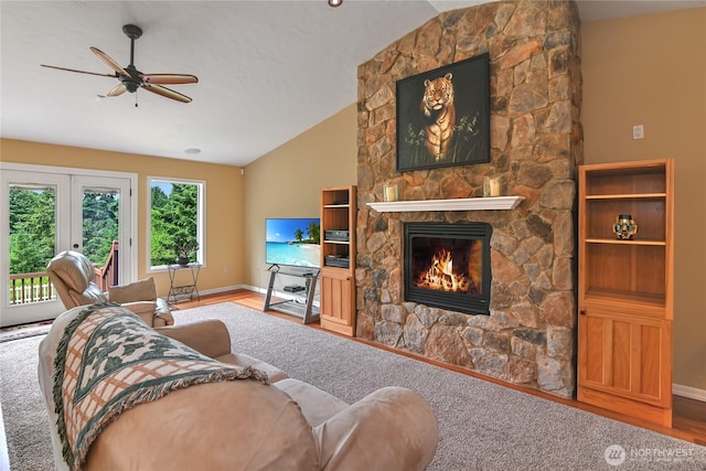 2360 Sapp Rd SW, Tumwater, WA 98512 - living room with vaulted ceiling, a fireplace, a ceiling fan, wood finished floors, and french doors