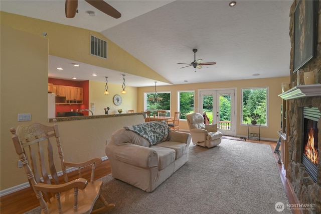 2360 Sapp Rd SW, Tumwater, WA 98512 - living area featuring ceiling fan, a stone fireplace, vaulted ceiling, wood finished floors, and recessed lighting