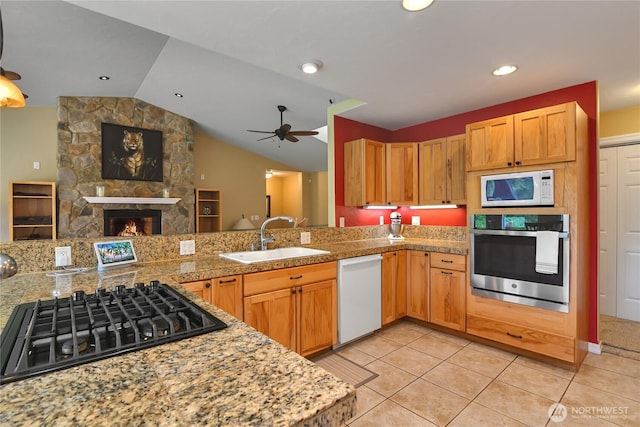 2360 Sapp Rd SW, Tumwater, WA 98512 - kitchen featuring white appliances, vaulted ceiling, a fireplace, a ceiling fan, and open floor plan