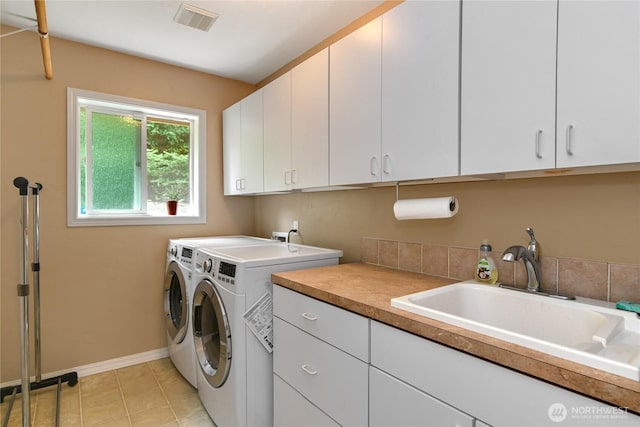 2360 Sapp Rd SW, Tumwater, WA 98512 - laundry area with cabinet space, separate washer and dryer, and light tile patterned floors