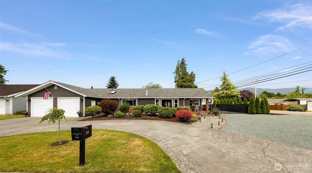 824 Orth Way, Sedro Woolley, WA 98284 - ranch-style home with curved driveway, a front lawn, a garage, and covered porch