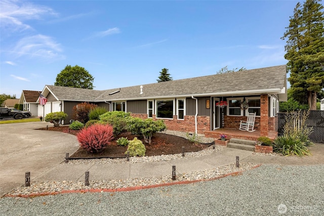 824 Orth Way, Sedro Woolley, WA 98284 - ranch-style house featuring covered porch, brick siding, a garage, driveway, and a shingled roof