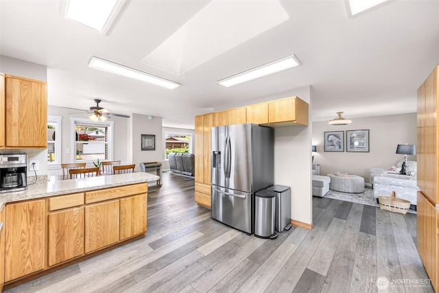 824 Orth Way, Sedro Woolley, WA 98284 - kitchen with stainless steel refrigerator with ice dispenser, open floor plan, wood finished floors, a peninsula, and a ceiling fan