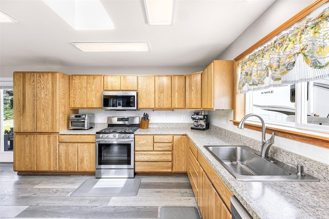 824 Orth Way, Sedro Woolley, WA 98284 - kitchen with appliances with stainless steel finishes, light countertops, and light wood finished floors