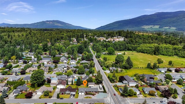 824 Orth Way, Sedro Woolley, WA 98284 - aerial perspective of suburban area featuring a mountainous background and a forest