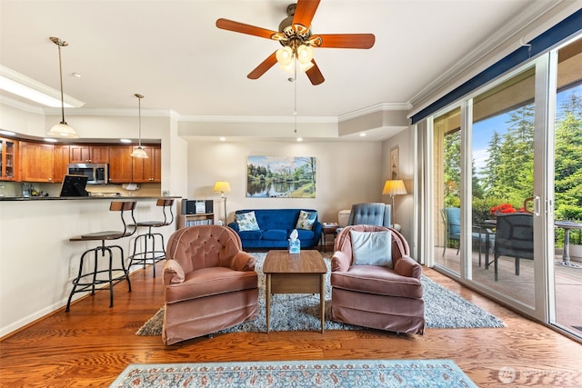 2440 S Steele St Unit 103, Tacoma, WA 98405 - living room featuring ornamental molding, wood finished floors, and a ceiling fan