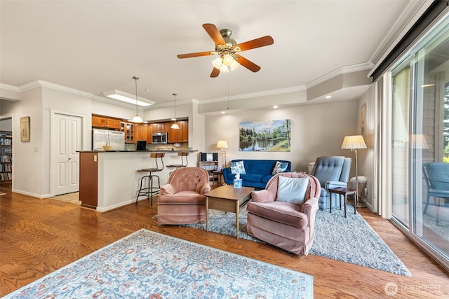 2440 S Steele St Unit 103, Tacoma, WA 98405 - living area with light wood-style floors, ornamental molding, and a ceiling fan