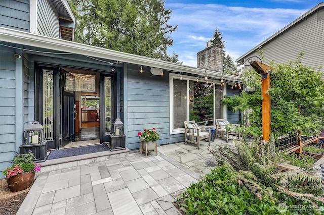 2212 186th Ave NE, Redmond, WA 98052 - view of exterior entry with a chimney and a patio