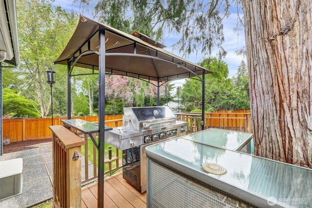 2212 186th Ave NE, Redmond, WA 98052 - deck with a gazebo, area for grilling, outdoor dining area, and view of scattered trees