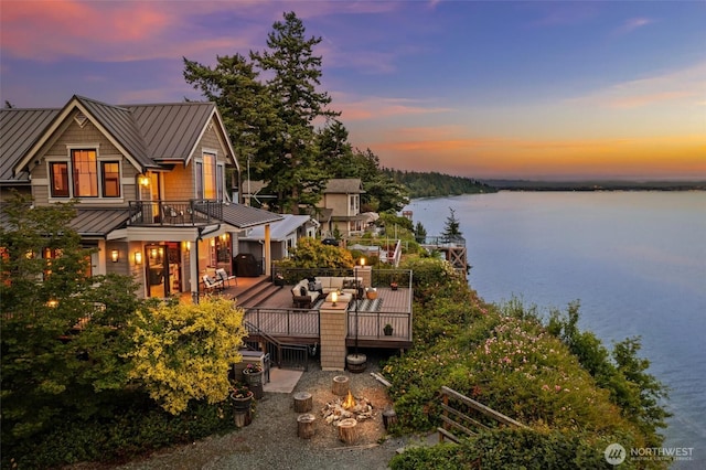 6117 39th Dr NW, Marysville, WA 98271 - rear view of house with a standing seam roof, a metal roof, and a deck with water view