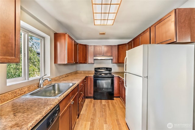6117 39th Dr NW, Marysville, WA 98271 - kitchen with freestanding refrigerator, black / electric stove, light wood-style floors, under cabinet range hood, and light countertops