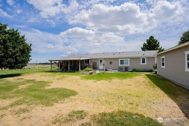 1448 Rd C NE, Moses Lake, WA 98837 - rear view of property featuring a yard