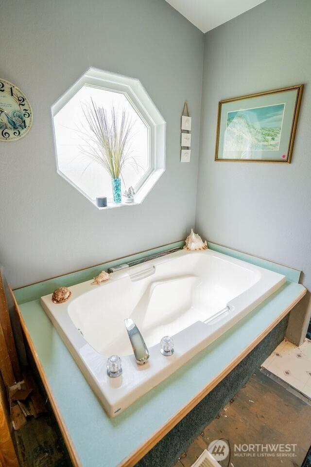 1448 Rd C NE, Moses Lake, WA 98837 - bathroom featuring a garden tub and wood finished floors