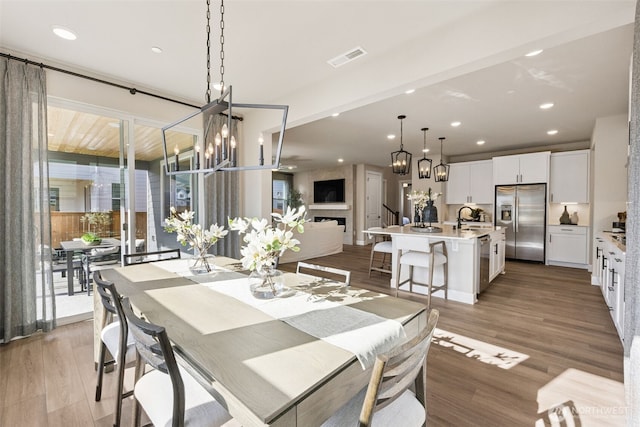 20259 145th St E Unit 856, Bonney Lake, WA 98391 - dining area with light wood-style floors, a chandelier, recessed lighting, and a fireplace