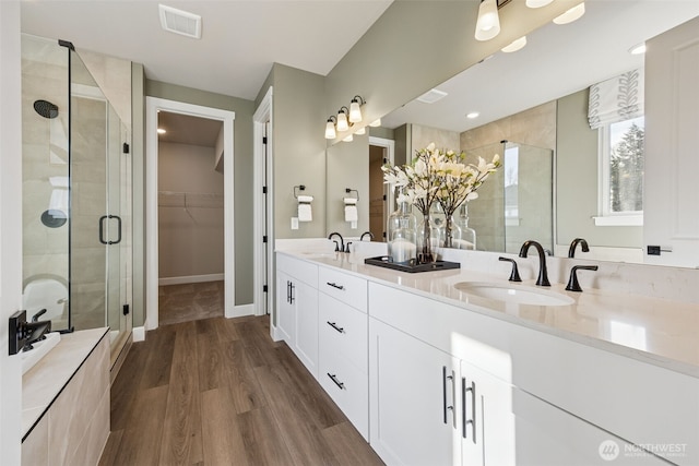 20259 145th St E Unit 856, Bonney Lake, WA 98391 - full bath featuring a stall shower, double vanity, wood finished floors, and a spacious closet