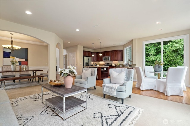 24826 SE 22nd Ct, Sammamish, WA 98075 - living room with arched walkways, a chandelier, and recessed lighting